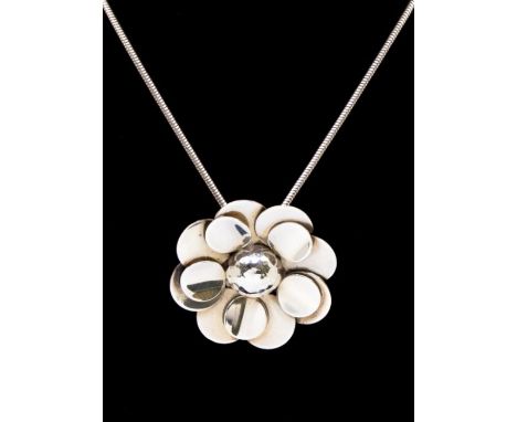 Tiangius Jackson- a silver pendant in the form or a flower with applied circular disc decoration and hammered dome centre, si