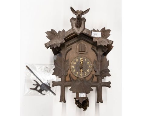 Cuckoo wall clock, two bellows, Black Forest-style case carved with deer, pediment leaf pendulum. 9cm dial, Arabic numerals. 