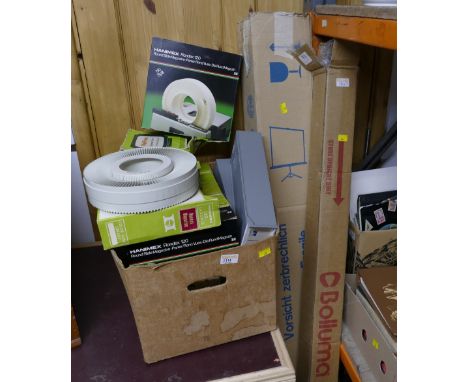 Two projector screens and box of slide viewers and magazines