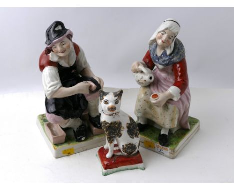 Male and female pair of Staffordshire figures and Staffordshire cat 