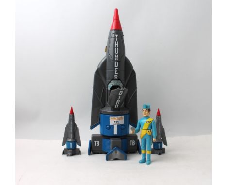 Thunderbird 1 dated 1999 with two smaller similar figures and Thunderbirds action figure also dated 1999