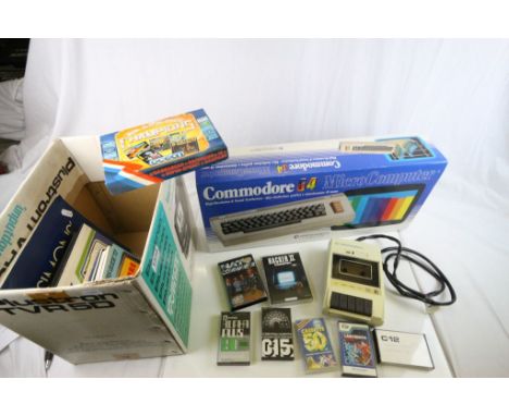 Boxed Commodore 64 gaming console plus a quantity fo cassette games and accessories