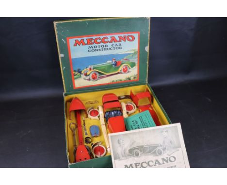 Boxed Meccano Motor Car Constructor complete and unused, with instructions, in red with cream tyres, plus a boxed Meccano M25