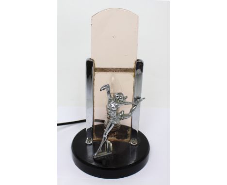 An Art Deco style table lamp with central female dancing figure in front of a glass panel/shade, height approx 27cm.