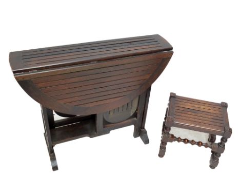 A circular drop-leaf table, with open sparred top and integral small lower tiers, made from timber removed from HMS Britannia