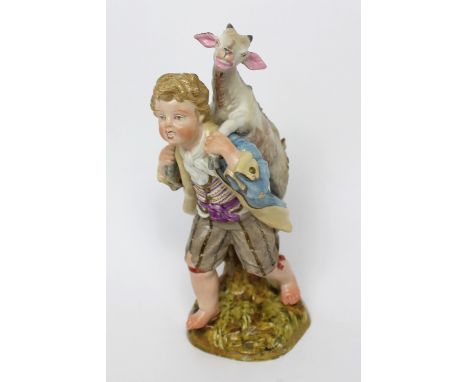 A 19th century Meissen figure group, boy in 18th century dress carrying a kid goat on his back, on naturalistic stone base, h