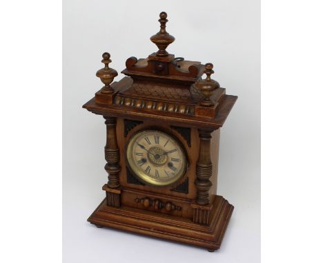 Hamburg American Clock Co; an oak-cased fourteen-day strike mantel clock with turned and knopped finials, the chapter ring se