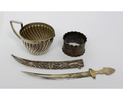 A Continental silver dagger with filigree scabbard, approx 1.5ozt and a white metal jug and napkin ring (3).