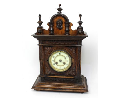 A German mahogany-cased eight-day mantel clock, the dial set with Roman numerals, height approx 45cm.