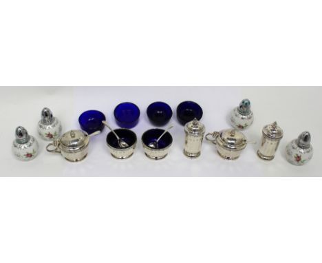 A cased George V hallmarked silver six piece condiment set, the mustard and salts with blue glass liners, Walker & Hall, 1932