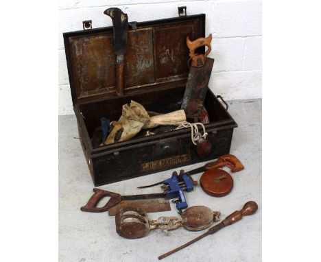 A metal trunk inscribed 'GHS Burrows' containing various woodworking tools, clamps and ships' pulley blocks.