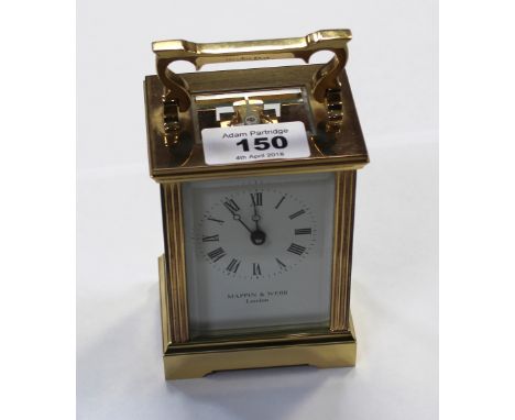 A Mappin & Webb brass-cased carriage clock, the circular dial set with Roman numerals, diameter 4.5cm, with eleven-jewel move