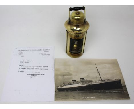 A brass binnacle lamp from the White Star Line ship 'M.V. Georgic', with turned wooden swing handle and accompanying document
