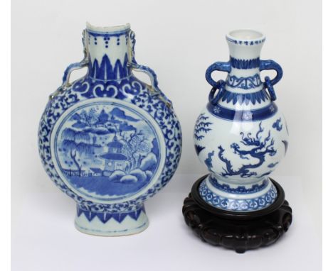 A 19th century Chinese blue and white moon flask vase, height 26cm (af) and a further Oriental blue and white vase with ring 