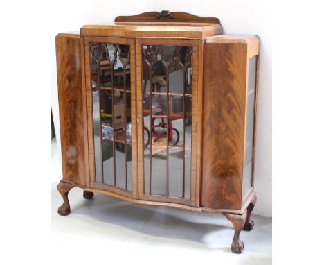 A mid-to-late 20th century mahogany bow-front display cabinet, strip glazed and supported on cabriole legs to ball and claw f