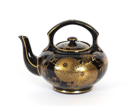 Attributed to Dr Christopher Dresser, a black glazed aesthetic movement teapot with oriental style gilt decoration, possibly 