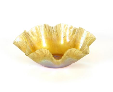 A Tiffany iridescent glass bowl of crimped form, marked to base L.C.T  R.4690, some damage, 15.5cm dia.