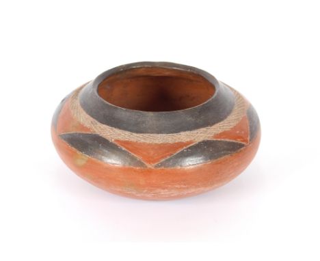 A vintage native American earthenware bowl, with geometric decoration