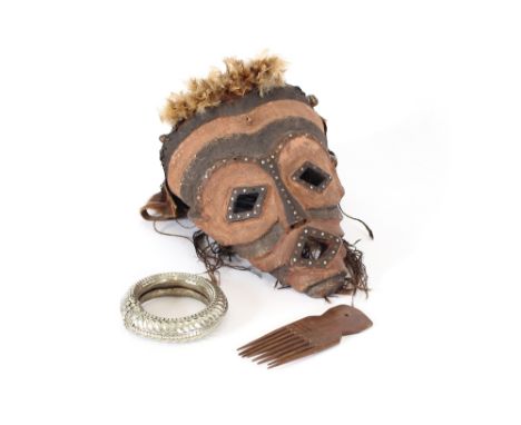 An ethnic face mask; a large white metal ethnic bangle; and an ethnic comb, (3)