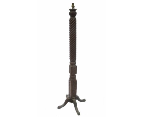 A converted standard lamp, from a turned mahogany pillar, raised on four splayed feet 