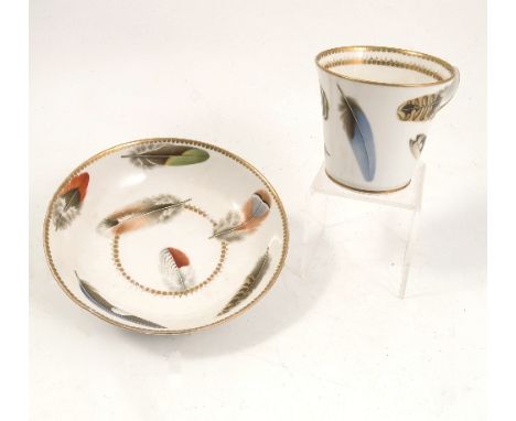 A 19th century Chamberlains Worcester cup and saucer, the ring handled cup and saucer decorated with various coloured feather