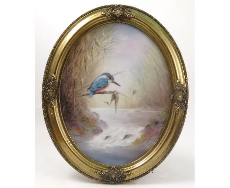 An oval porcelain plaque, decorated with a kingfisher by a Royal Worcester porcelain artist M Powell, maximum diameter 13.5in