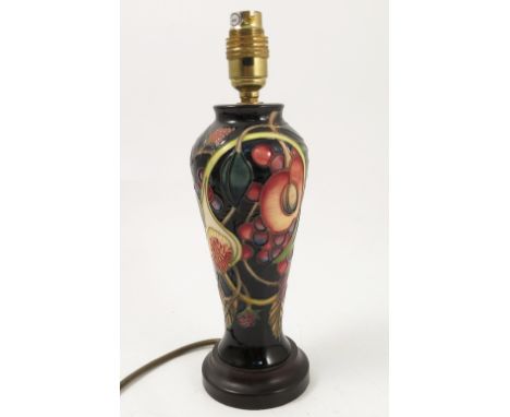 A modern Moorcroft Pottery lamp base, decorated in the Pomegranate pattern, on a wooden base, height 12ins Condition report: 