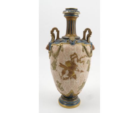 A Royal Worcester vase, with fluted neck, pierced handles with lion masks, the body moulded with masks and swags, decorated w