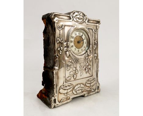 A silver mounted mantel clock, of shaped rectangular form, the silver case embossed with flowers and leaves in the Art Nouvea