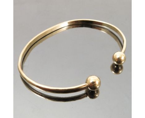 A torque bangle, in unmarked gold, weight 11.7g gross, cased 