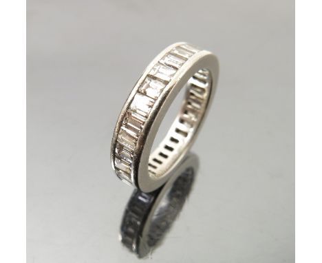 A Tiffany & Co platinum and diamond eternity ring, set with baguette cut diamonds, marked PT 950, in a Tiffany & Co bag Condi