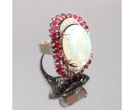 An opal, diamond and ruby ring, the white mount stamped '14K', the shallow oval cabochon measuring 18.6mm x 14mm, together wi