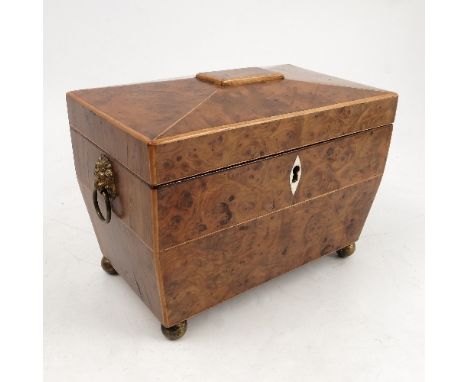 A 19th century burr wood tea caddy, of sarcophagus form, with satinwood stringing, the interior fitted with two covered compa
