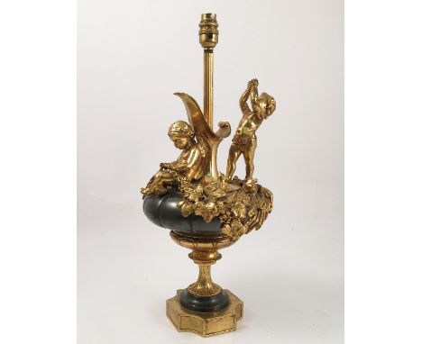 A metal and gilt table lamp, in the form of a ewer, with putti and foliage, the base stamped 'Vitloz Bronzier A Paris', heigh