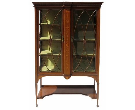 An Edwardian mahogany display cabinet, fitted with two astragal glazed doors opening to reveal shelves, with central inlaid d