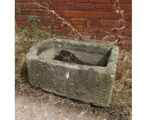 A rectangular shaped stone trough 