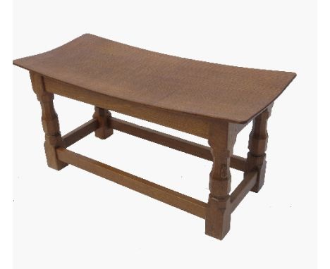 An oak long stool, or table, raised on four legs united by a stretcher, by Robert 'Mouseman' Thompson of Kilburn, 32ins x 14.