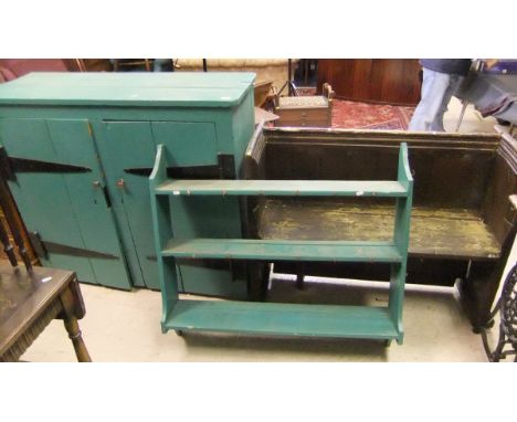 A stained pine pew, together with a painted pine two door cupboard and similarly painted three shelf wall unit