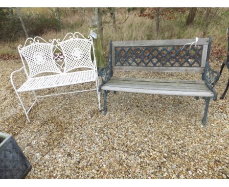 A cast metal garden bench with wooden slats, together with a further painted wrought iron garden seat with lattice work decor