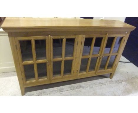 A modern teak four door glazed display cabinet on square tapered legs CONDITION REPORTS Some light scratches and impressed ma