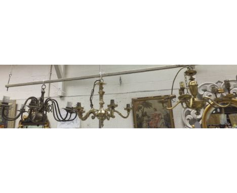 A brass six branch electrolier in the Dutch taste, two brass five branch electroliers, together with a box of various wall li