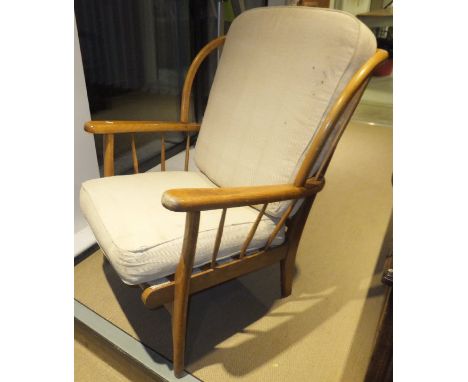 An Ercol style stained beech framed armchair and an Ercol elm coffee table CONDITION REPORTS The chair is in the Ercol style/
