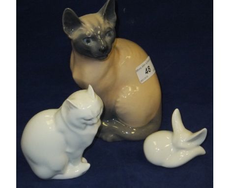 A Royal Copenhagen porcelain figure of a Siamese cat, model 3281, together with a Herend porcelain figure of a seated cat and