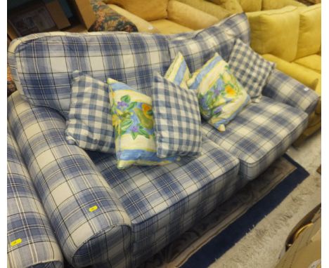 A two seater sofa bed and single armchair in a blue and white tartan upholstery