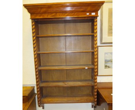 A late 19th Century satin birch wood hanging shelf unit, the shaped cornice above various shelves, flanked by half cut barley