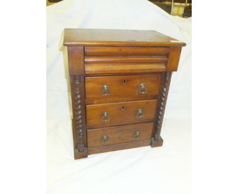 A Victorian mahogany miniature Scotch chest with cushion drawer above three long drawers flanked by barley-twist pilasters on