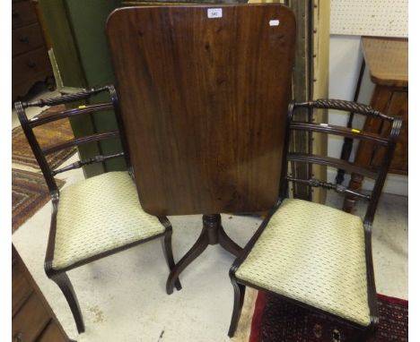 A 19th Century mahogany rectangular tilt-top occasional table on ringed central pedestal to hipped tripod base, together with