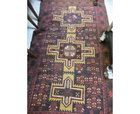 A Persian rug, the three central medallions in mustard on a blue medallion decorated ground within blue and red star and arro