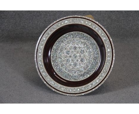 A large Egyptian micro mosaic mother of pearl and bone inlaid charger with a geometric design. Diam. 36cm 