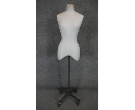 A vintage mannequin on metal adjustable four spoke stand on casters. H.148cm 